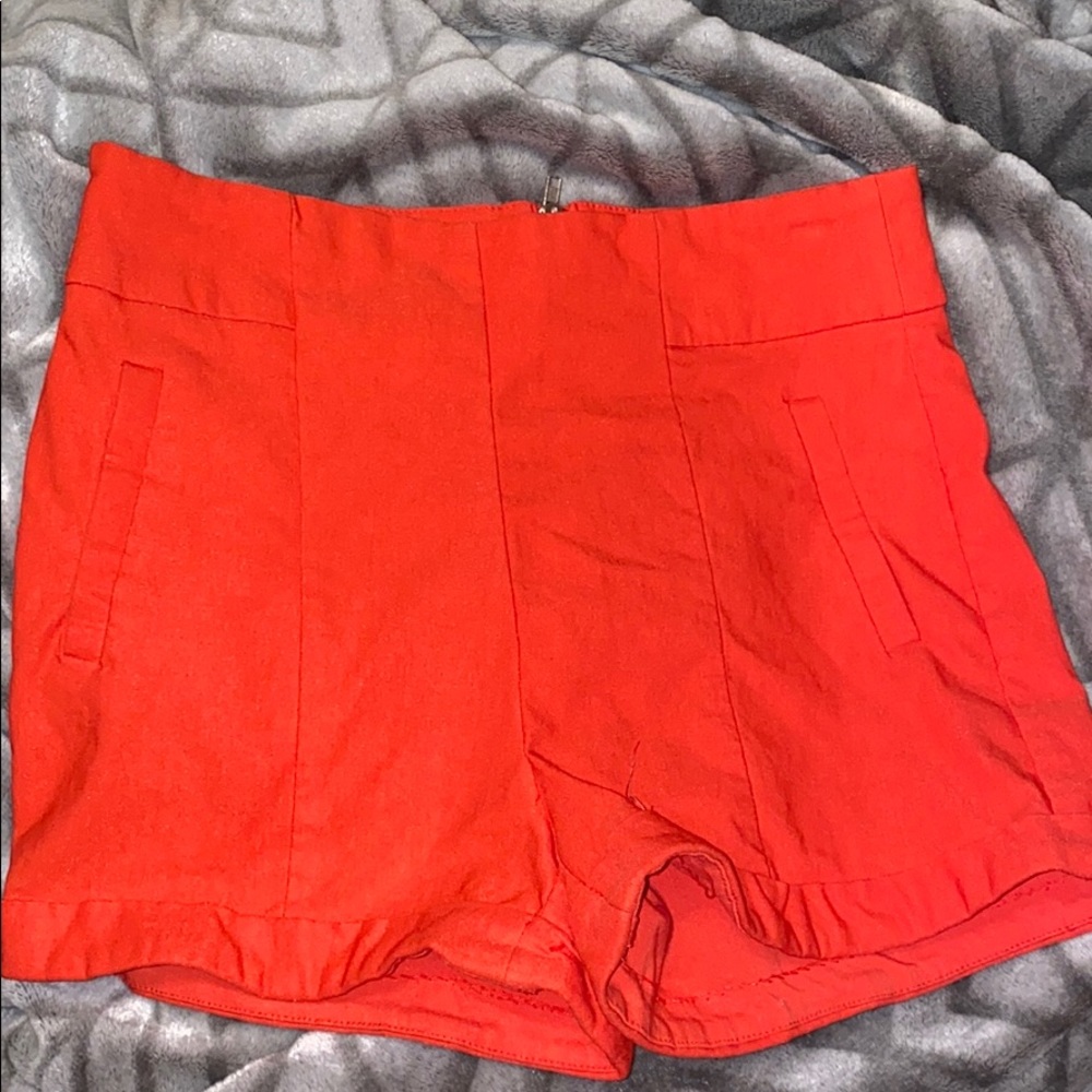 Reddish, orangish shorts. Size M